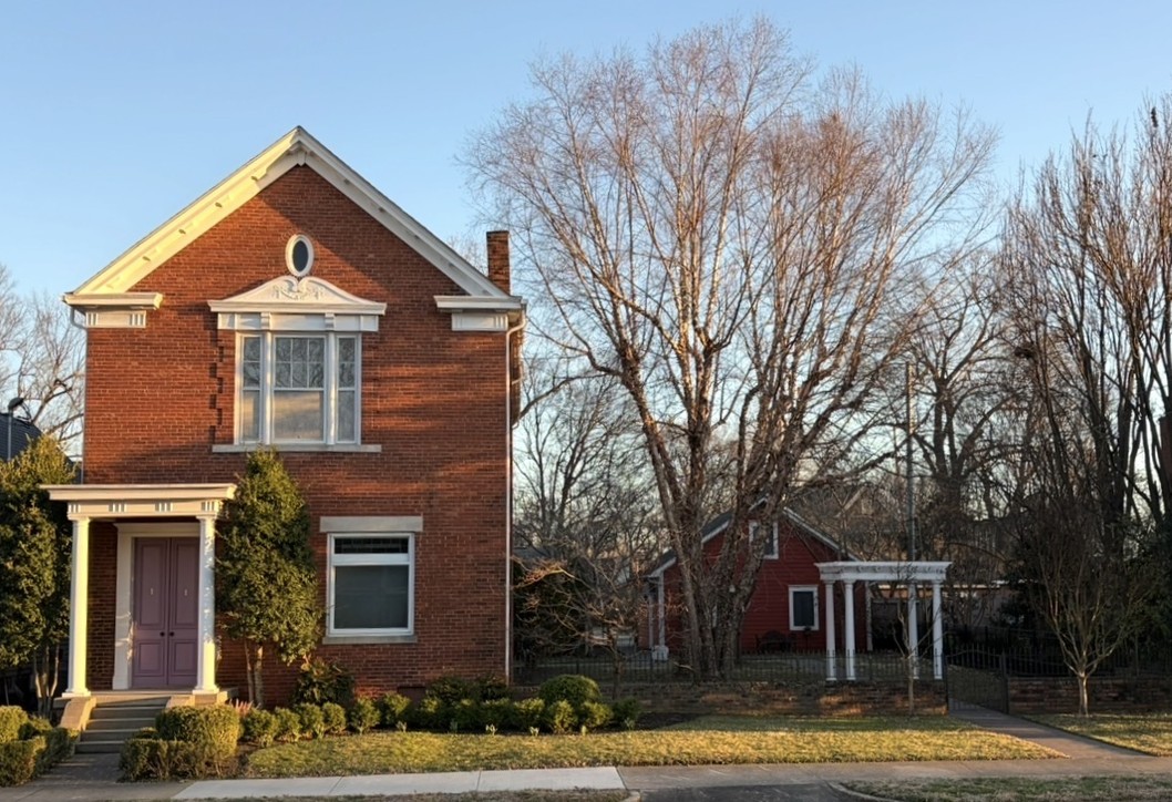 brick two story house with garden
